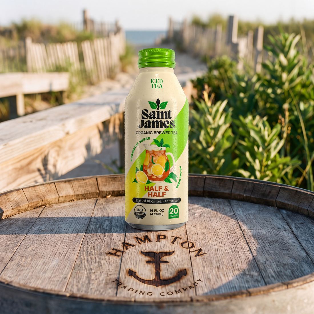 Saint James Half & Half organic brewed iced tea bottle on a Hampton Trading Company barrel at a dune crossing